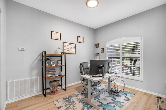 office space with light wood-type flooring