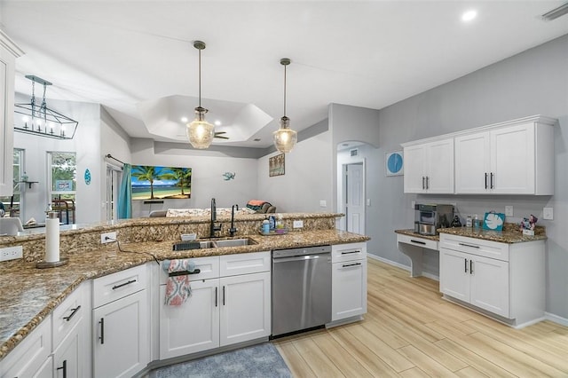 kitchen featuring dishwasher, sink, hanging light fixtures, and white cabinets