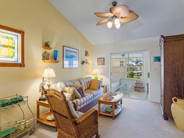 living room with ceiling fan, light colored carpet, and vaulted ceiling