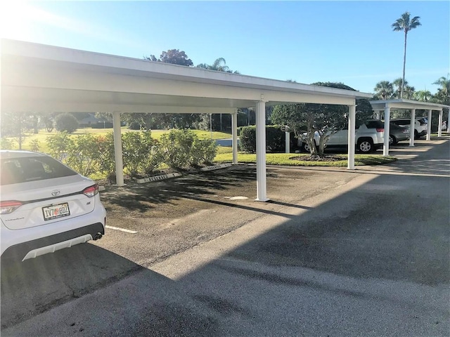 view of vehicle parking with a carport