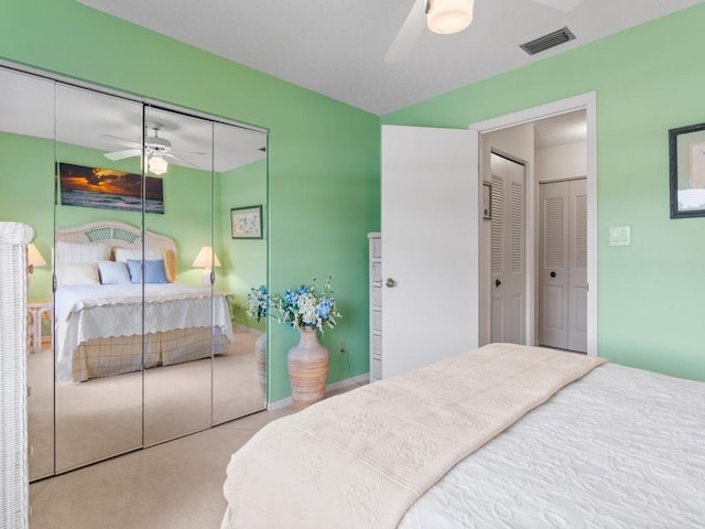 bedroom featuring ceiling fan and light carpet