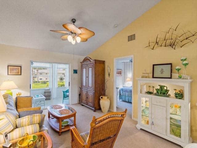 carpeted living room with ceiling fan and lofted ceiling