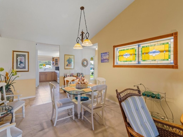 tiled dining space with vaulted ceiling