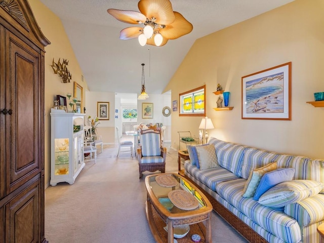 carpeted living room featuring ceiling fan and lofted ceiling