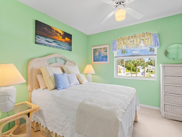 bedroom with light colored carpet and ceiling fan