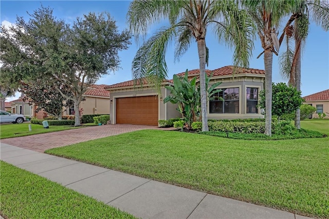 mediterranean / spanish house with a front lawn and a garage