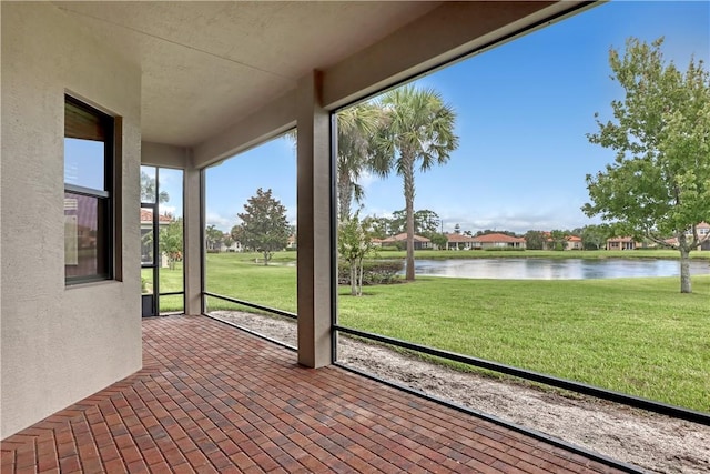 unfurnished sunroom with a water view