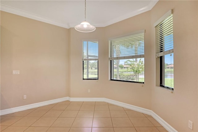 unfurnished room featuring ornamental molding and light tile patterned flooring