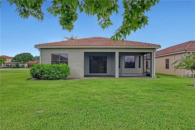 rear view of house with a yard