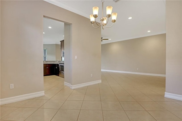 empty room with light tile patterned floors, ceiling fan with notable chandelier, and ornamental molding