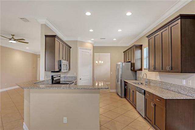 kitchen featuring kitchen peninsula, sink, appliances with stainless steel finishes, light stone counters, and ceiling fan with notable chandelier