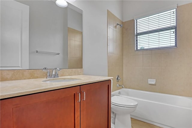 full bathroom with toilet, tiled shower / bath combo, tile patterned floors, and vanity