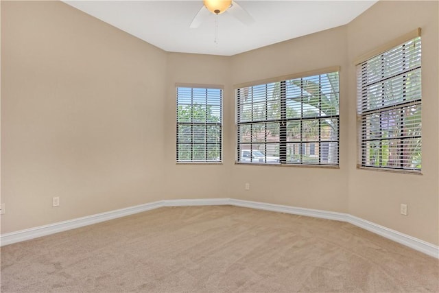 carpeted empty room featuring ceiling fan