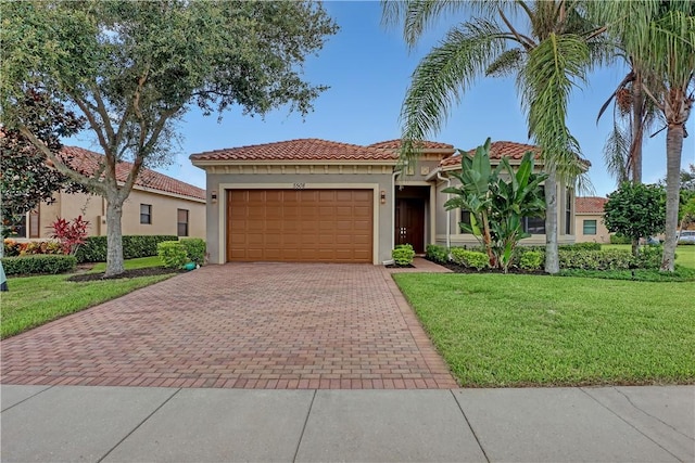 mediterranean / spanish house with a front yard and a garage