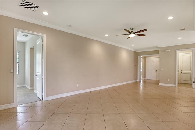 tiled spare room featuring ceiling fan and ornamental molding