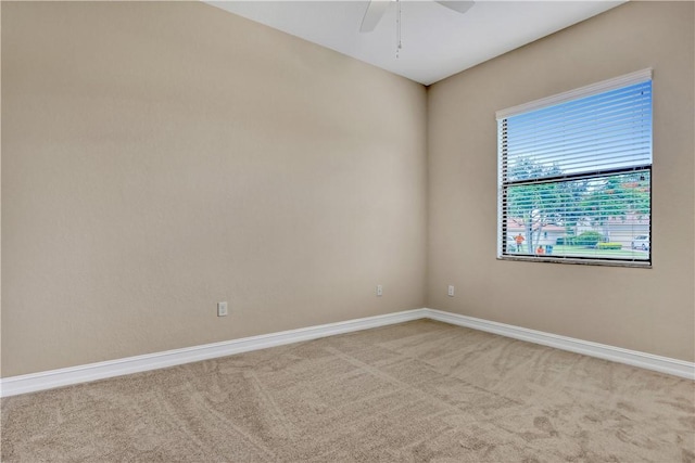 empty room with ceiling fan and carpet