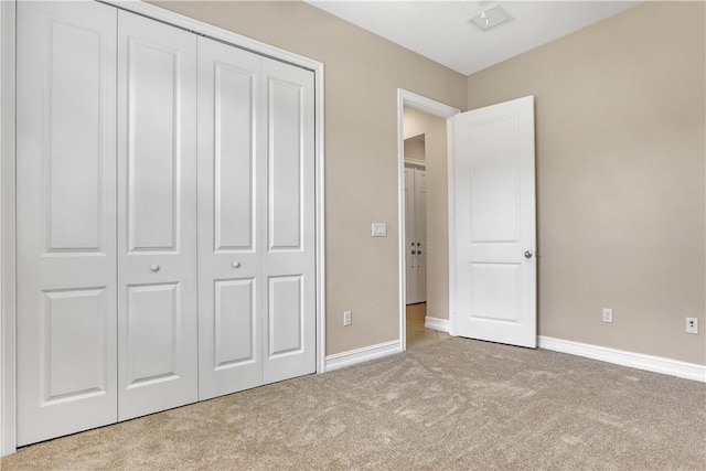 unfurnished bedroom featuring a closet and carpet floors