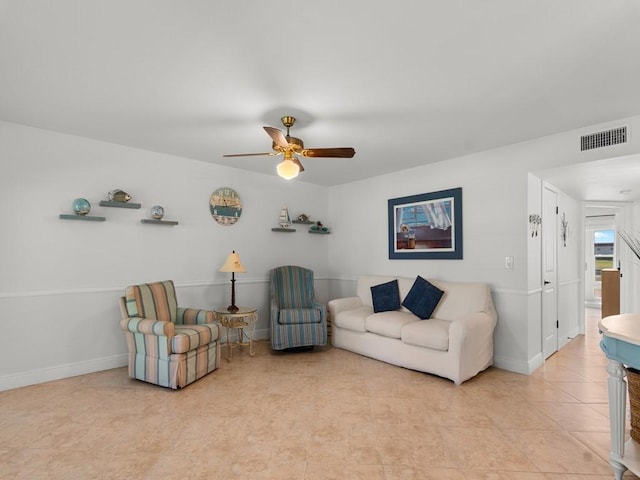living room with visible vents, baseboards, ceiling fan, and light tile patterned floors