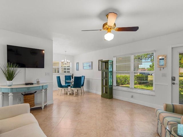 living area featuring light tile patterned floors, baseboards, and a healthy amount of sunlight