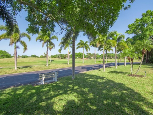 view of community featuring a yard and golf course view