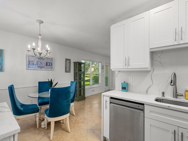 kitchen with white cabinets, a notable chandelier, light stone counters, a sink, and stainless steel dishwasher