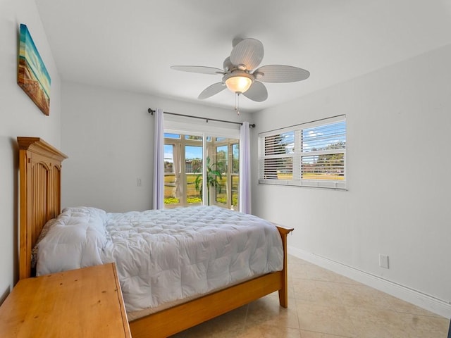 bedroom featuring baseboards, a ceiling fan, light tile patterned floors, and access to exterior