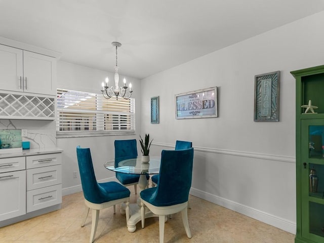 dining space featuring an inviting chandelier and baseboards