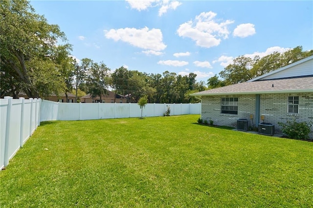 view of yard featuring central AC and a fenced backyard