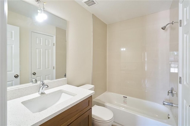 bathroom with vanity, toilet, visible vents, and shower / bathtub combination