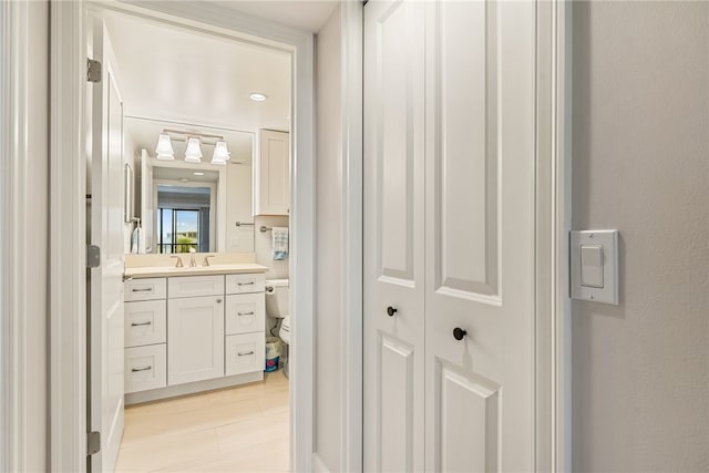 bathroom featuring vanity and toilet