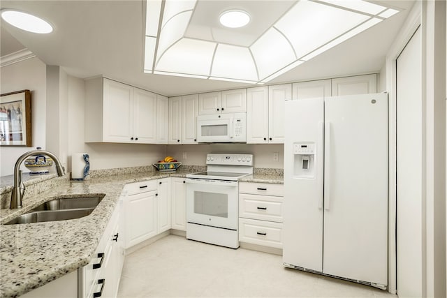 kitchen with light stone countertops, sink, crown molding, white appliances, and white cabinets