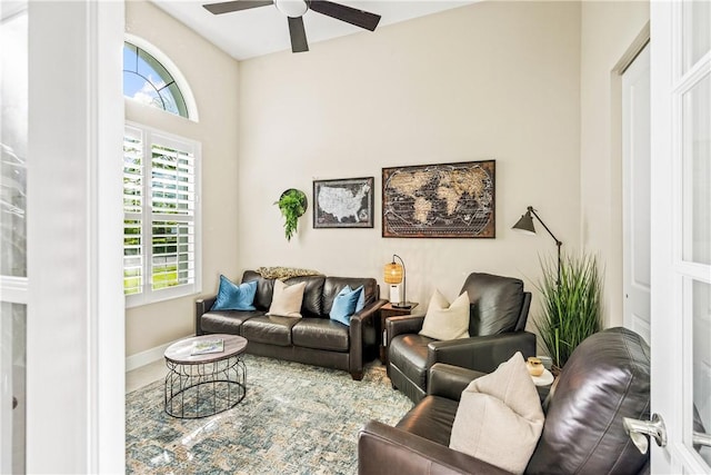 living room featuring ceiling fan and a healthy amount of sunlight