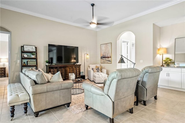 tiled living room with ceiling fan and crown molding