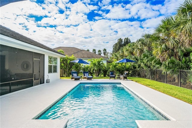 view of pool with a lawn and a patio area