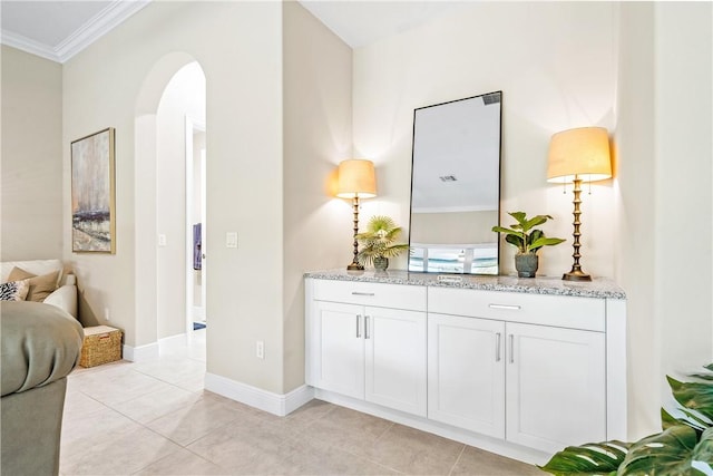 hall with light tile patterned floors and crown molding