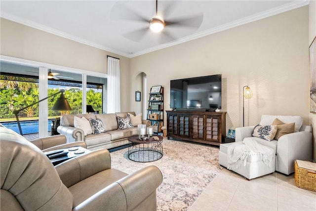 tiled living room featuring ceiling fan and crown molding