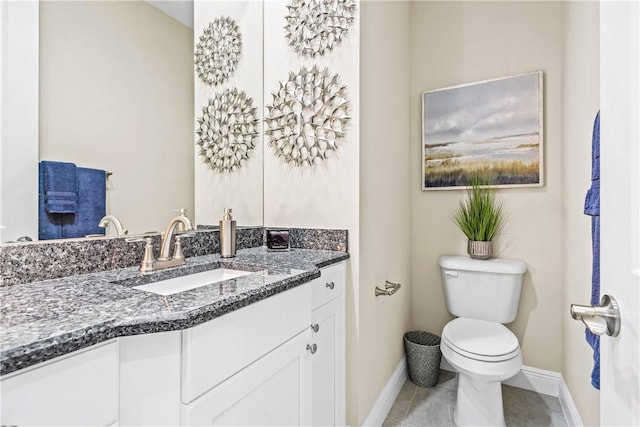 bathroom with tile patterned flooring, vanity, and toilet