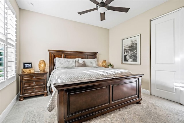 bedroom featuring multiple windows and ceiling fan