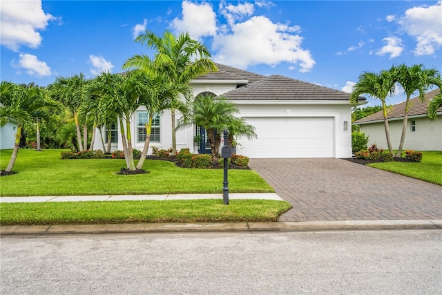 view of front of home featuring a front yard and a garage