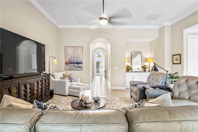 tiled living room featuring ceiling fan and ornamental molding