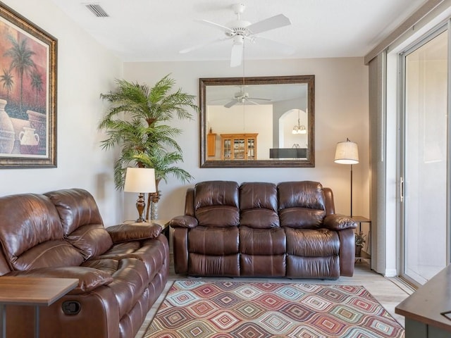 living room featuring ceiling fan and light wood-type flooring