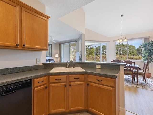 kitchen with kitchen peninsula, light wood-type flooring, ceiling fan with notable chandelier, sink, and dishwasher