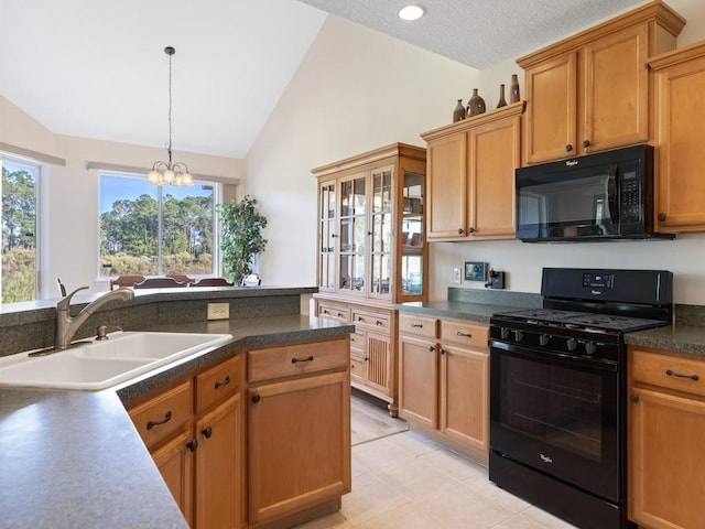 kitchen with sink, black appliances, pendant lighting, a chandelier, and lofted ceiling