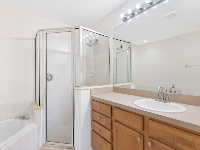 bathroom with shower with separate bathtub and vanity