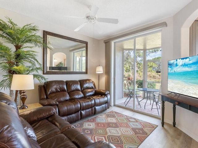 living room featuring hardwood / wood-style flooring and ceiling fan