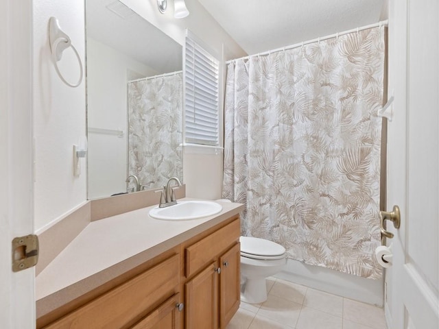 bathroom with tile patterned flooring, vanity, and toilet