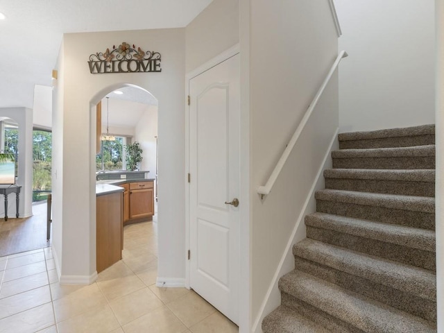 stairs with tile patterned floors