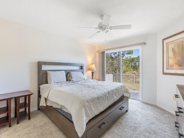 carpeted bedroom with a textured ceiling, access to outside, and ceiling fan