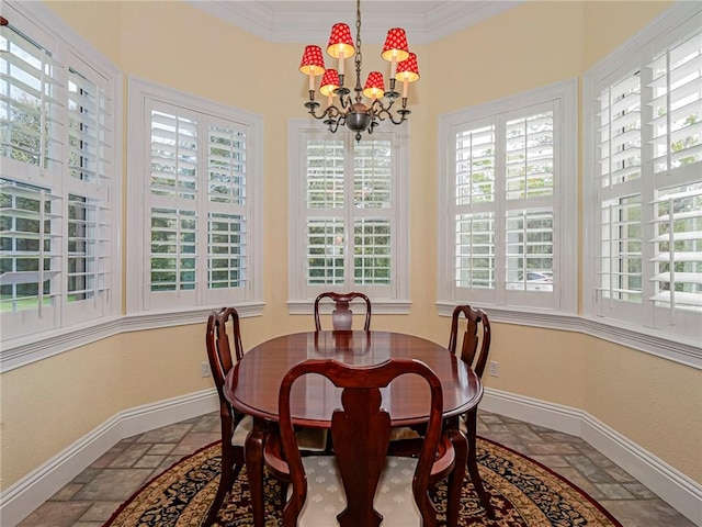 dining room with a notable chandelier, ornamental molding, and a healthy amount of sunlight