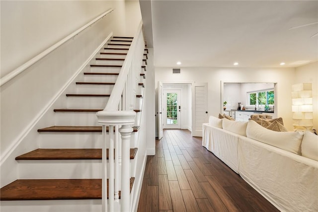 stairs with recessed lighting, visible vents, baseboards, and wood finished floors